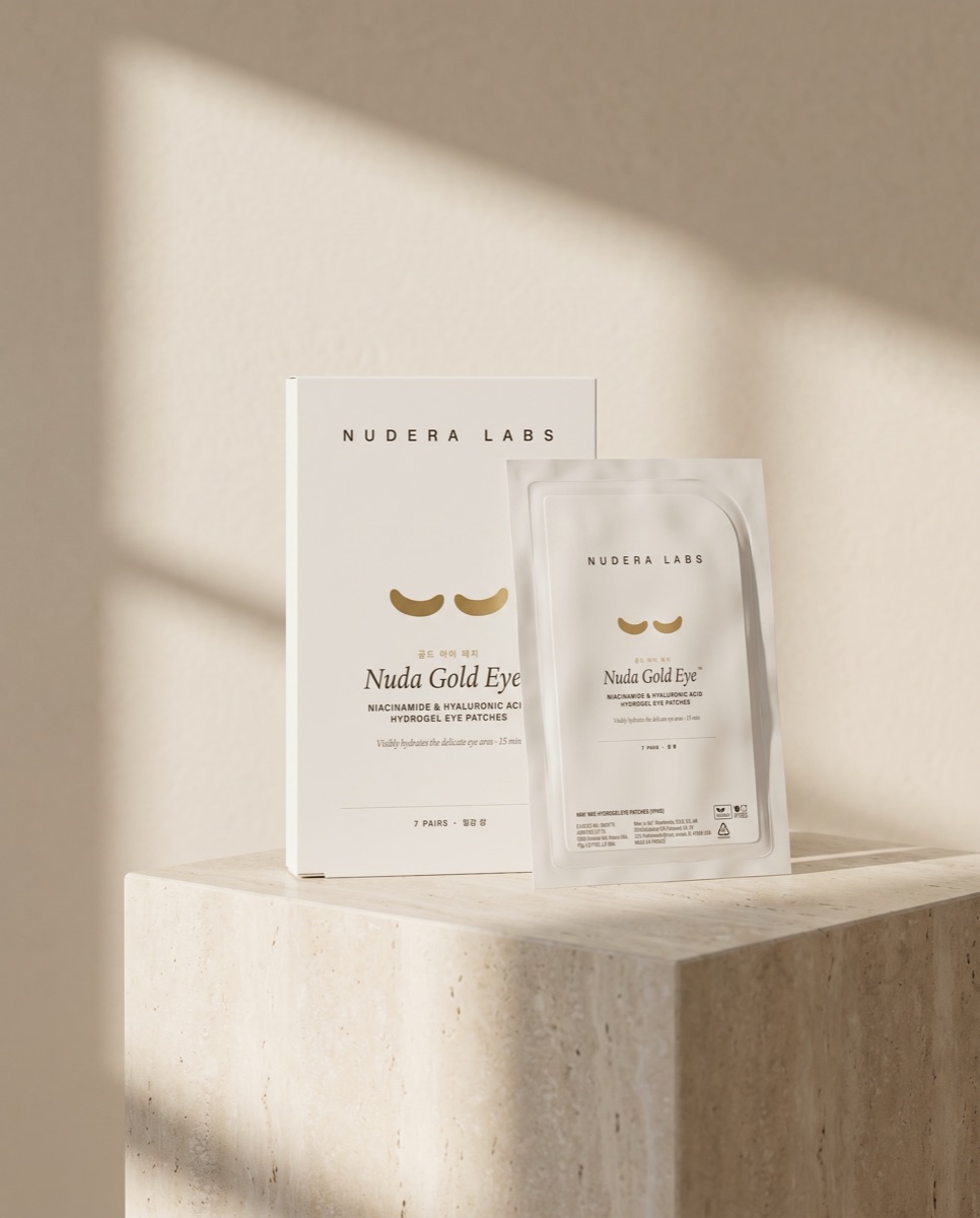 Nuda Gold Eye patch box and sachet on travertine